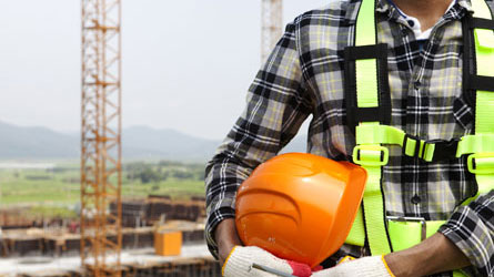 Man at work covered by site manager insurance with a hard hat on.