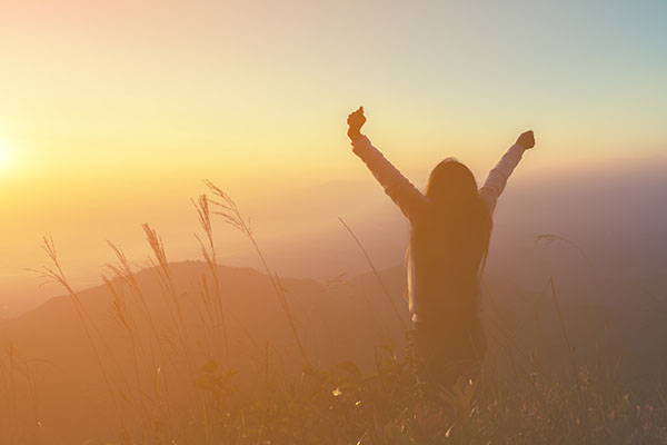 Person enjoying the sunset, looking completely stress-free