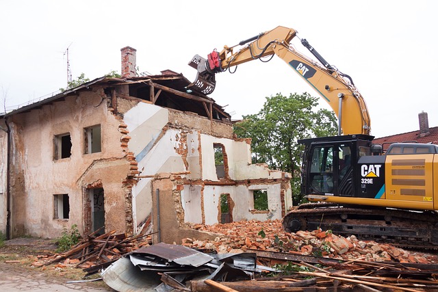 Building being demolished by CAT vehicle