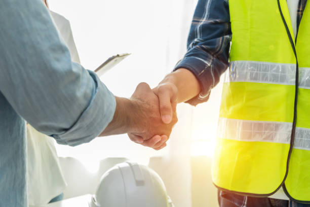 Tradesman and client shake hands after agreeing more business